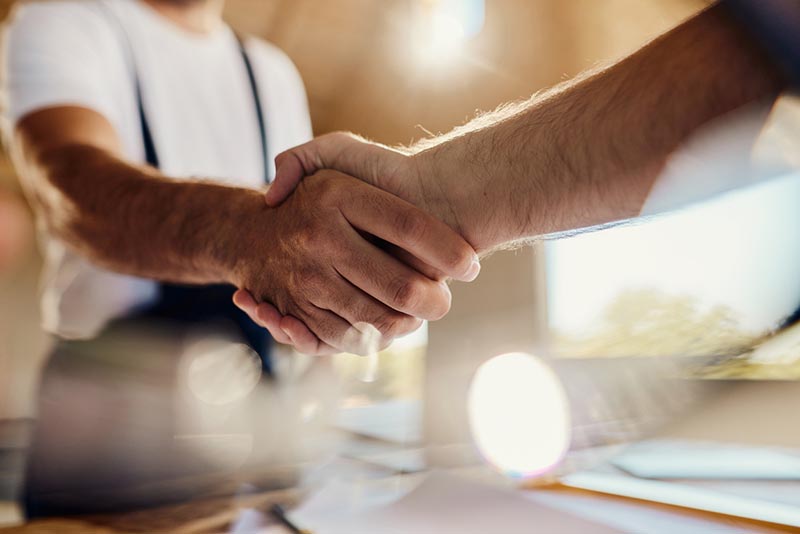A handshake after executing a surety bond to secure business